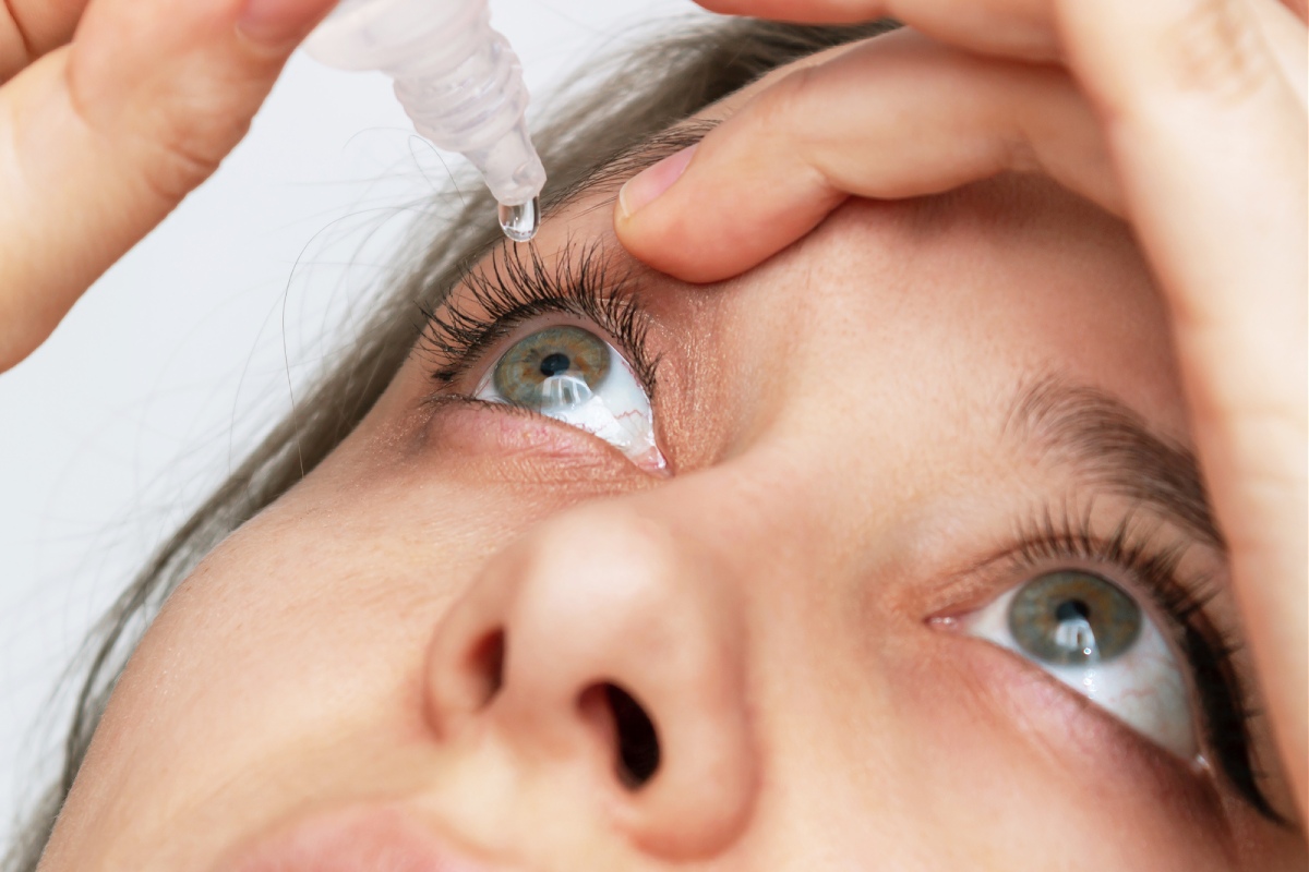 woman using eye drops